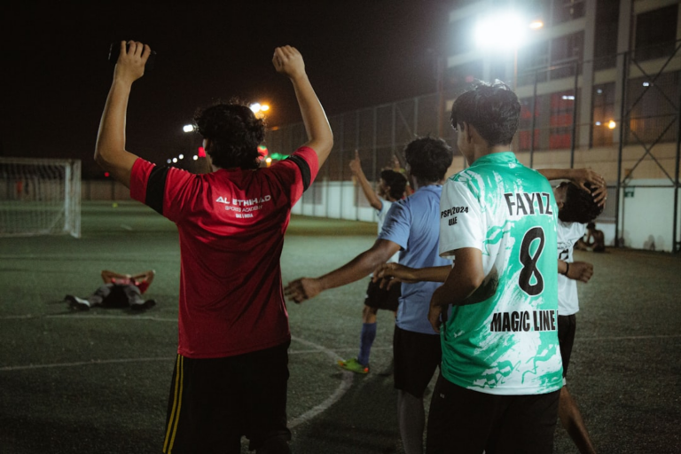 a group of people standing on top of a soccer field — Foto por Fahim mohammed jaseem na Unsplash